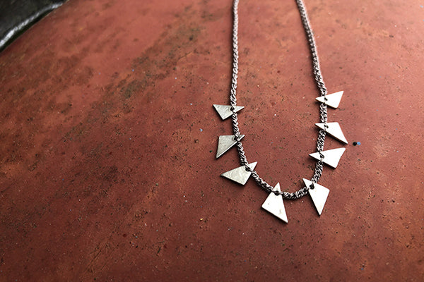 The Good Supply in Pemaquid Maine Textile Artist Erica Schlueter of Bent Metal Crocheted Shile Thread and Sterling Silver Jewelry Triangle Shards Necklace in Gray Made in USA